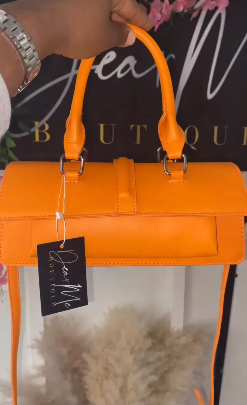 women's vibrant orange handbag with adjustable strap and double handles
