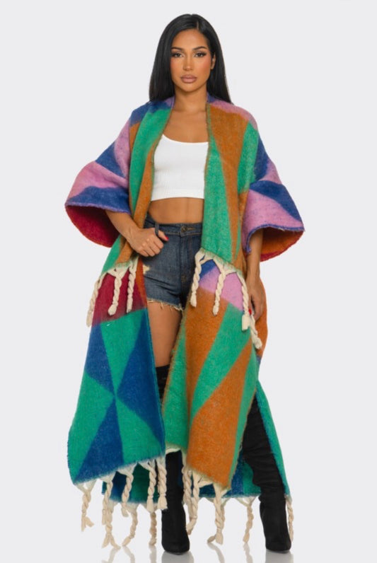 Woman wearing a colorful patterned cardigan
 on a white background